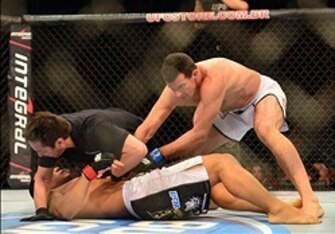 Referee Mario Yamasaki calls a halt to Perosh's fight with Magalhaes.