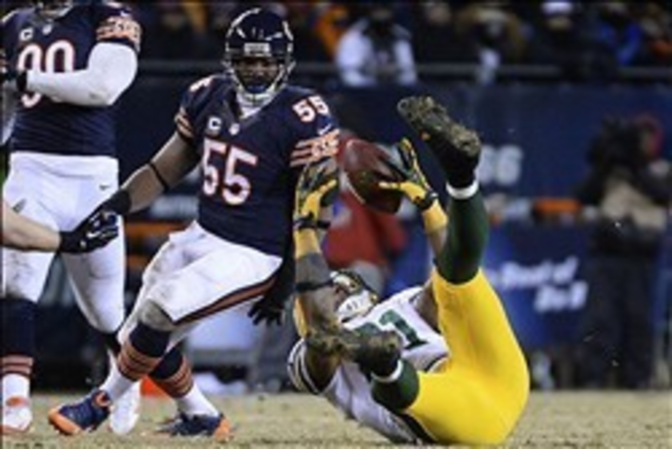 Dec 29, 2013; Chicago, IL, USA; Green Bay Packers tight end Andrew Quarless (81) attempts to make a catch against Chicago Bears outside linebacker Lance Briggs (55) during the fourth quarter at Soldier Field. The Green Bay Packers win 33-28. Mandatory Cre