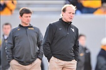 Holgorsen (right) better win soon if he hopes to remain in Morgantown.