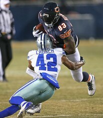CHICAGO, IL - DECEMBER 09: Martellus Bennett #83 of the Chicago Bears tries to break a tackle by Barry Church #42 of the Dallas Cowboys at Soldier Field on December 9, 2013 in Chicago, Illinois. The Bears defeated the Cowboys 45-28.  (Photo by Jonathan Da