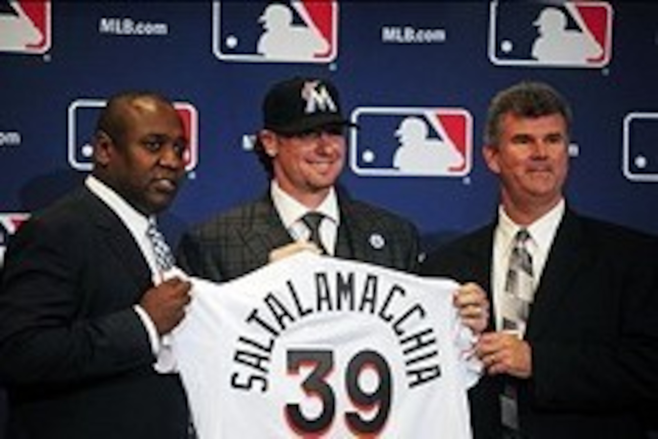 Dec 9, 2013; Orlando, FL, USA; Catcher Jarrod Saltalamacchia (center) is introduced by Miami Marlins director of baseball operations Michael Hill (left) and general manager Dan Jennings (right) during the MLB Winter Meetings at the Walt Disney World Swan 