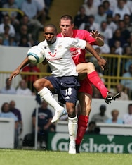 Defoe and Jamie Carragher battle it out on the opening day of 2003-04.