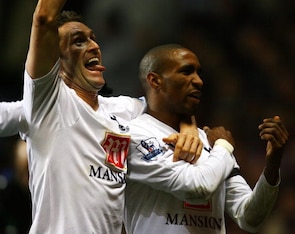Defoe celebrates his last goal for Spurs alongside teammate and rival Robbie Keane.