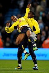 Defoe and Sebastien Bassong celebrate Champions League qualification.