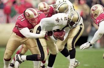 A man with a name above all others—Cedric Killings (No. 71) sacks New Orleans Saints quarterback Aaron Brooks.