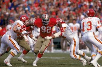 SAN FRANCISCO - DECEMBER 14:  Defensive end Tim Harris #92 of the San Francisco 49ers goes after quarterback Mark Vlasic #12 of the Kasas City Chiefs as he splits between two of the Chiefs offensive lineman Rich Baldinger #77 and David Lutz #72 during a g