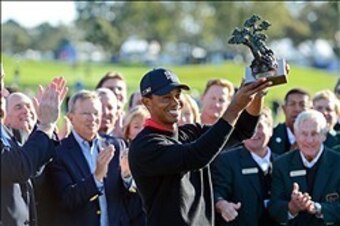 Proudly displaying this trophy has become a regular routine for Tiger Woods.