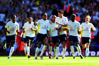 LONDON, ENGLAND - AUGUST 16:  Benoit Assou-Ekotto (C) of Tottenham is congratulated by teammates after scoring the opening goal during the Barclays Premier League match between Tottenham Hotspur and Liverpool at White Hart Lane on August 16, 2009 in Londo
