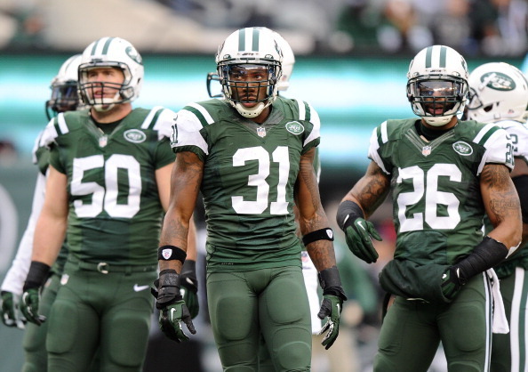 Antonio Cromartie (center) with Garrett McIntyre (left) and Dawan Landry (right).