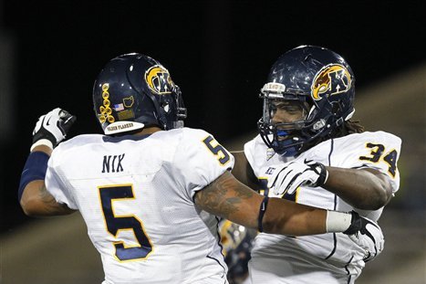 Kent State's Roosevelt Nix (5) and Traylon Durham (34) celebrate an interception against Buffalo during the second half of an NCAA college football game in Amherst, N.Y., Wednesday, Sept. 19, 2012. Kent State won 23-7. (AP Photo/Bill Wippert)