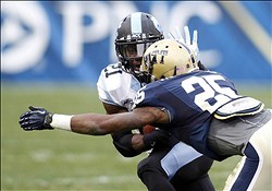 Nov 16, 2013; Pittsburgh, PA, USA; North Carolina Tar Heels running back Romar Morris (21) runs after a pass reception as Pittsburgh Panthers defensive back Jason Hendricks (25) defends during the third quarter against at Heinz Field. The Tar Heels won 34