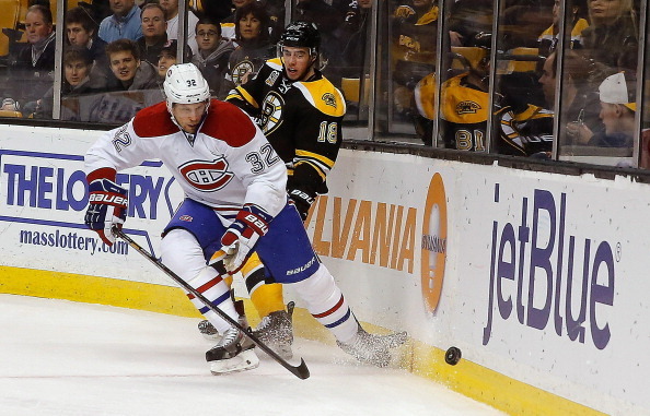 Montreal Canadiens forward Travis Moen and Boston Bruins forward Reilly Smith.