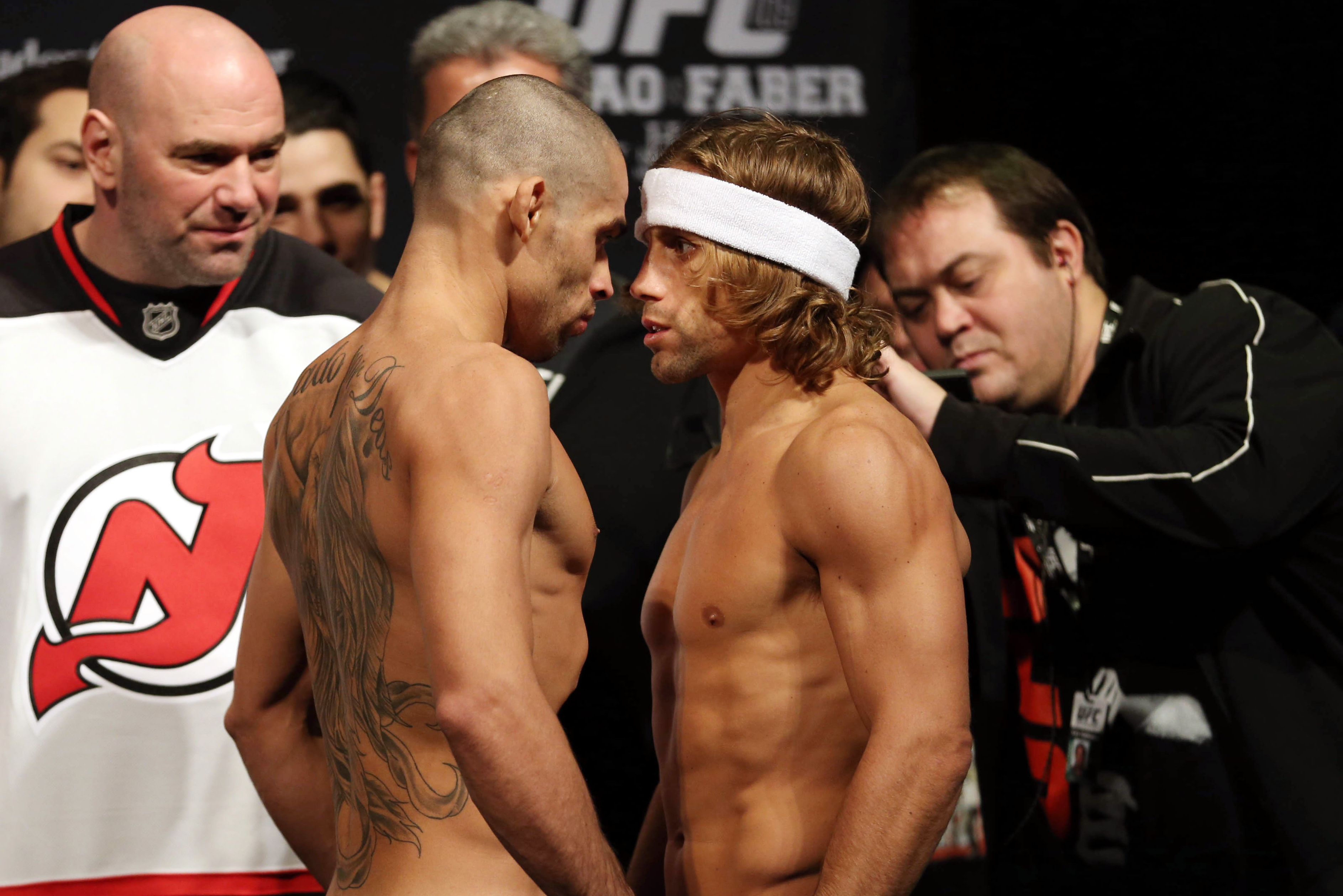 Urijah Faber (right) and Renan Barao face off before their bout at UFC 169.