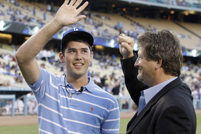 Dodgers VP of Amateur Scouting Logan White, right, introduces Zach Lee to fans at Dodger Stadium back in 2010.