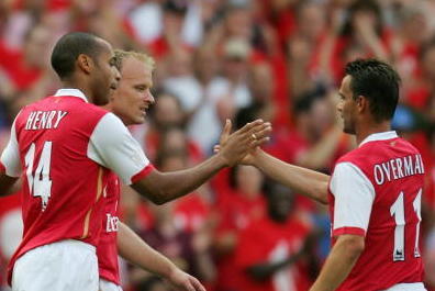 LONDON - JULY 22:  Thierry Henry (L) of Arsenal, is congratulated by teammates Dennis Bergkamp (C) and Marc Overmars (R), after scoring a goal during the Dennis Bergkamp testimonial match between Arsenal and Ajax at the Emirates Stadium on July 22, 2006 i