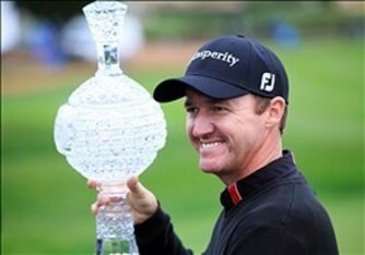 Jimmy Walker holding the AT&T Pebble Beach National Pro-Am trophy