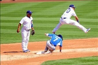 Mar 16, 2013; Phoenix, AZ, USA; Chicago Cubs short stop Javier Baez (70) jumps over Kansas City Royals base runner David Lough (7) in the second inning during a spring training game against the Kansas City Royals at HoHoKam stadium. Mandatory Credit: Jenn
