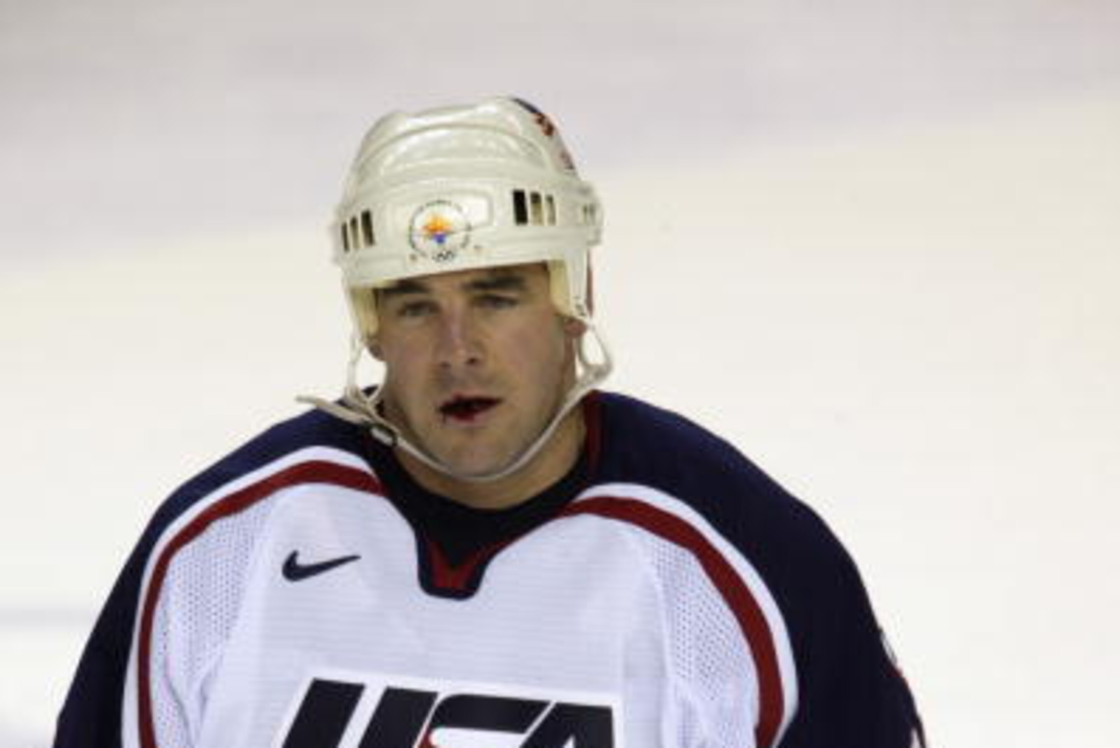 SALT LAKE CITY - FEBRUARY 20:  John LeClair #10 of the USA looks on from the ice after being hit in the mouth against Germany during the game at the Salt Lake City Winter Olympics at the E Center on February 20, 2002 in Salt Lake City, Utah. (Photo by Bri