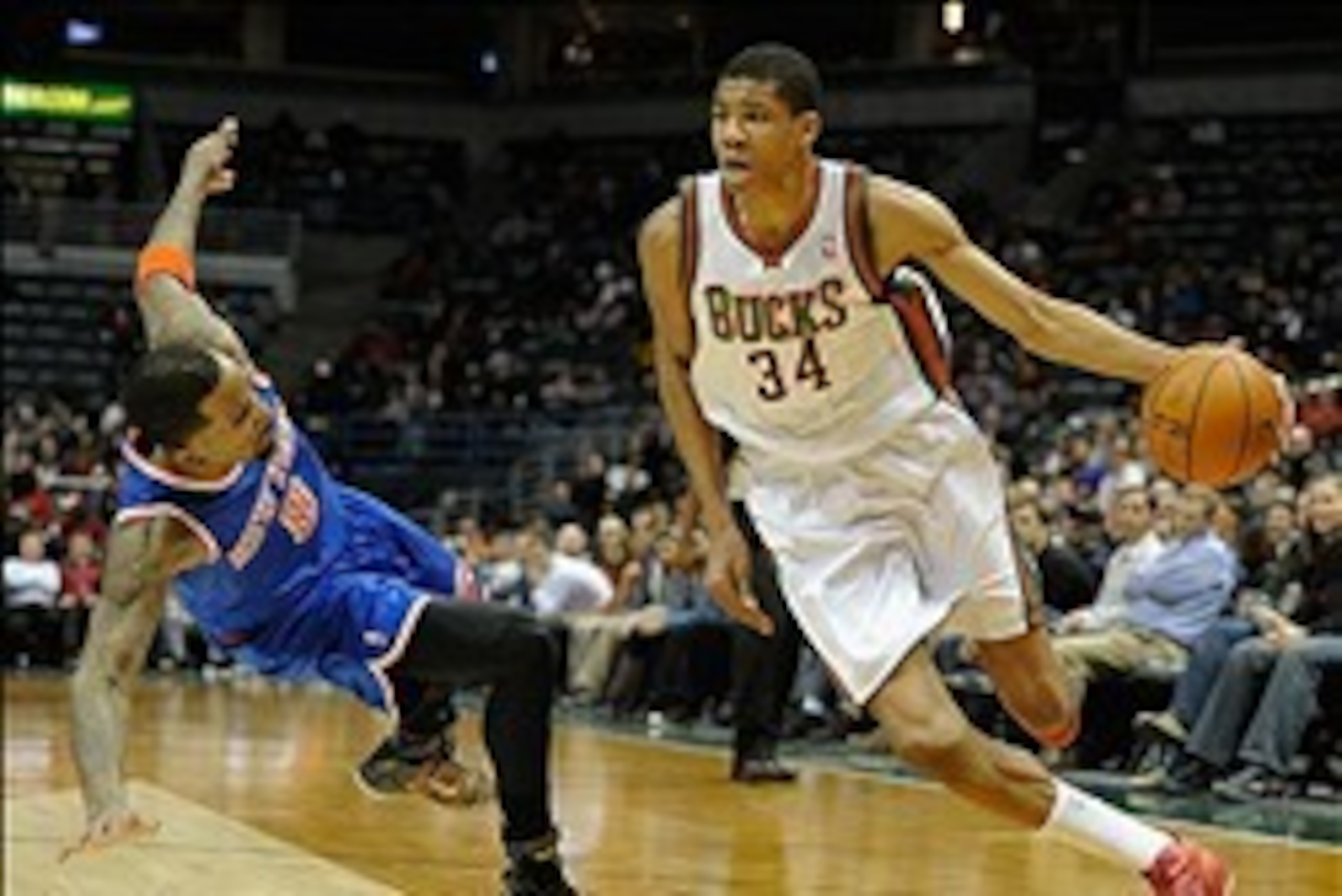 Feb 3, 2014; Milwaukee, WI, USA;  Milwaukee Bucks guard Giannis Antetokounmpo (34) drives past New York Knicks guard J.R. Smith (8) in the 4th quarter at BMO Harris Bradley Center. Mandatory Credit: Benny Sieu-USA TODAY Sports