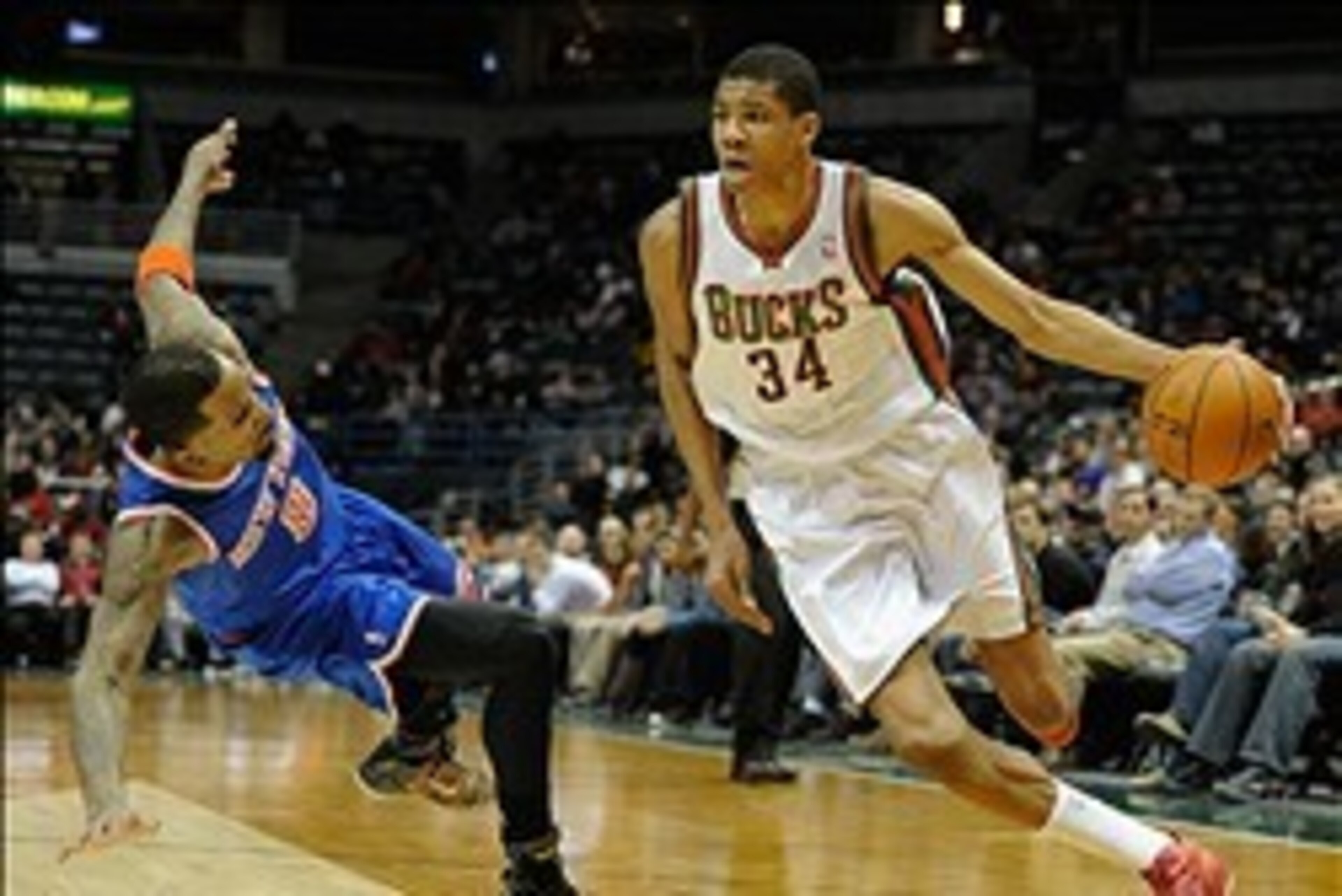 Feb 3, 2014; Milwaukee, WI, USA;  Milwaukee Bucks guard Giannis Antetokounmpo (34) drives past New York Knicks guard J.R. Smith (8) in the 4th quarter at BMO Harris Bradley Center. Mandatory Credit: Benny Sieu-USA TODAY Sports