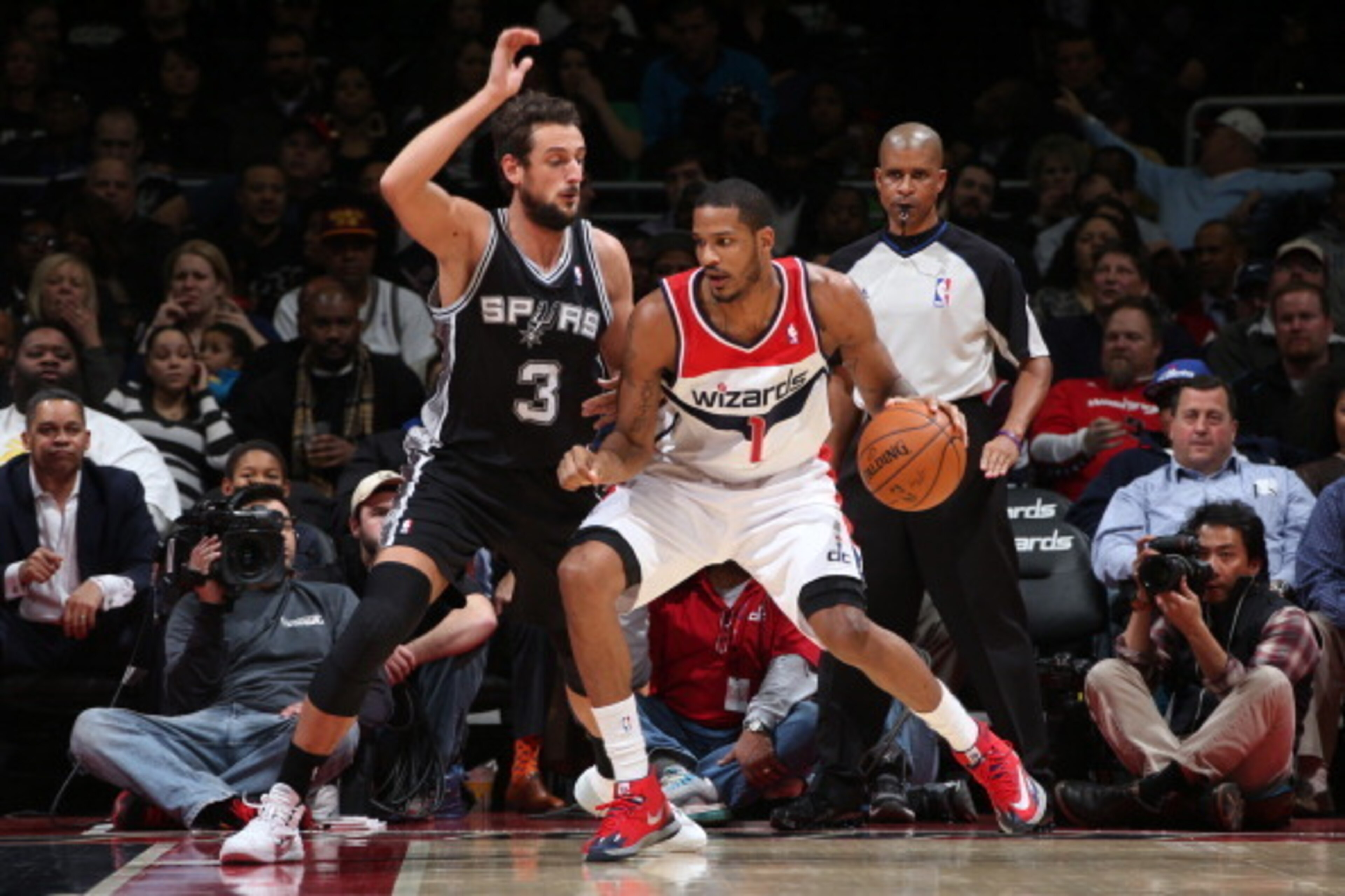 WASHINGTON, DC - FEBRUARY 5: Trevor Ariza #1 of the Washington Wizards drives against Marco Belinelli #3 of the San Antonio Spurs at the Verizon Center on February 5, 2014 in Washington, DC. NOTE TO USER: User expressly acknowledges and agrees that, by do
