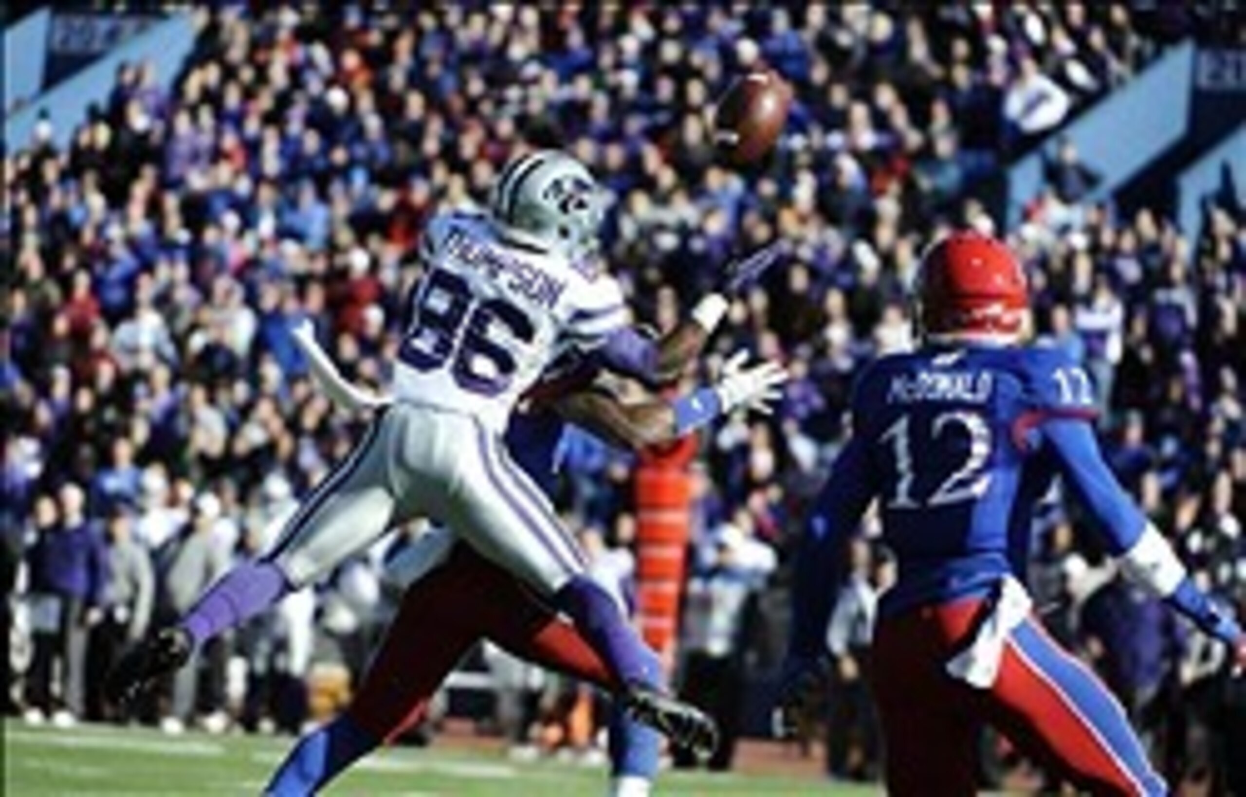 Nov 30, 2013; Lawrence, KS, USA; Kansas State Wildcats wide receiver Tramaine Thompson (86) is unable to catch this pass while defended by Kansas Jayhawks safety Dexter Linton (23) and cornerback Dexter McDonald (12) in the first half at Memorial Stadium.