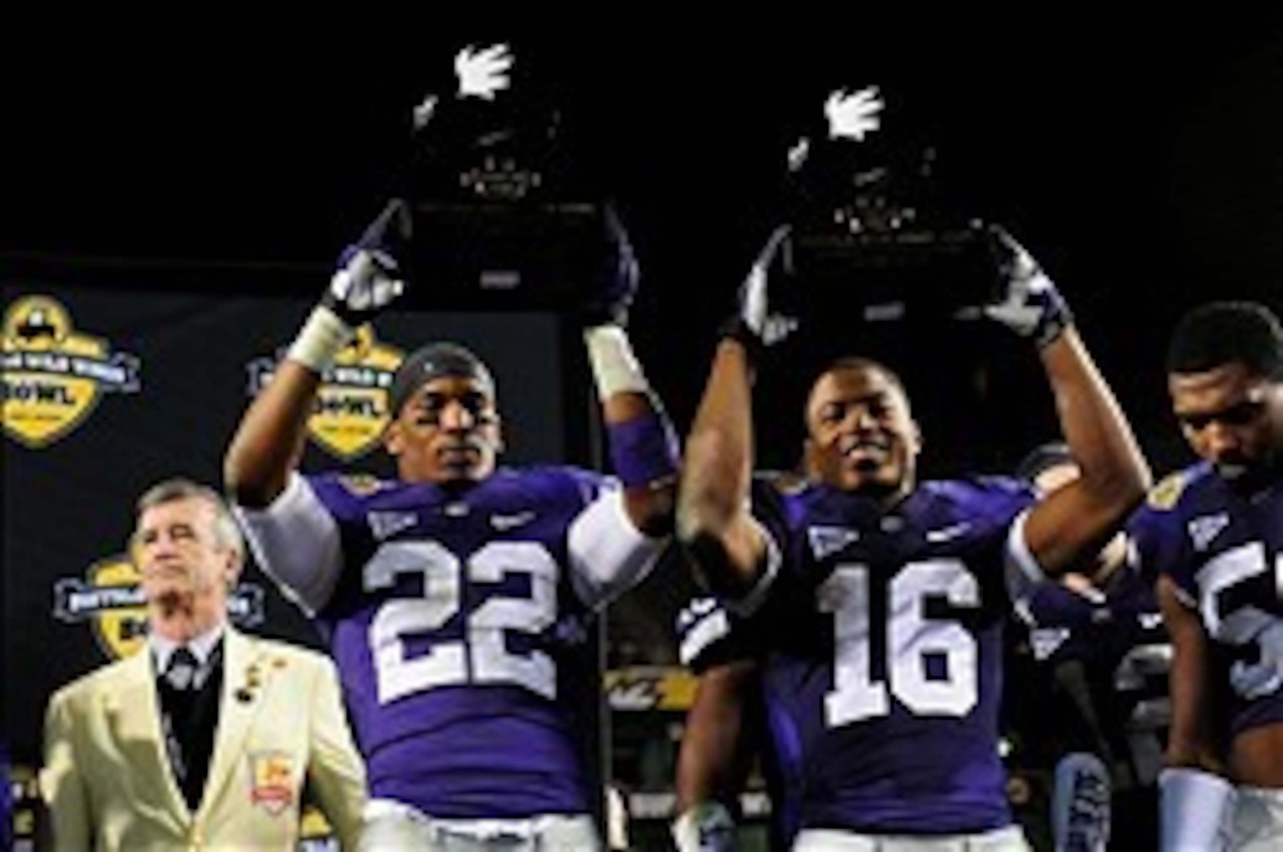 Dec 28, 2013; Tempe, AZ, USA; Kansas State Wildcats defensive back Carl Miles Jr. (2) and wide receiver Tyler Lockett (16) celebrate after winning defensive and offensive players of the game after beating the Michigan Wolverines 31-14 in the Buffalo Wild 