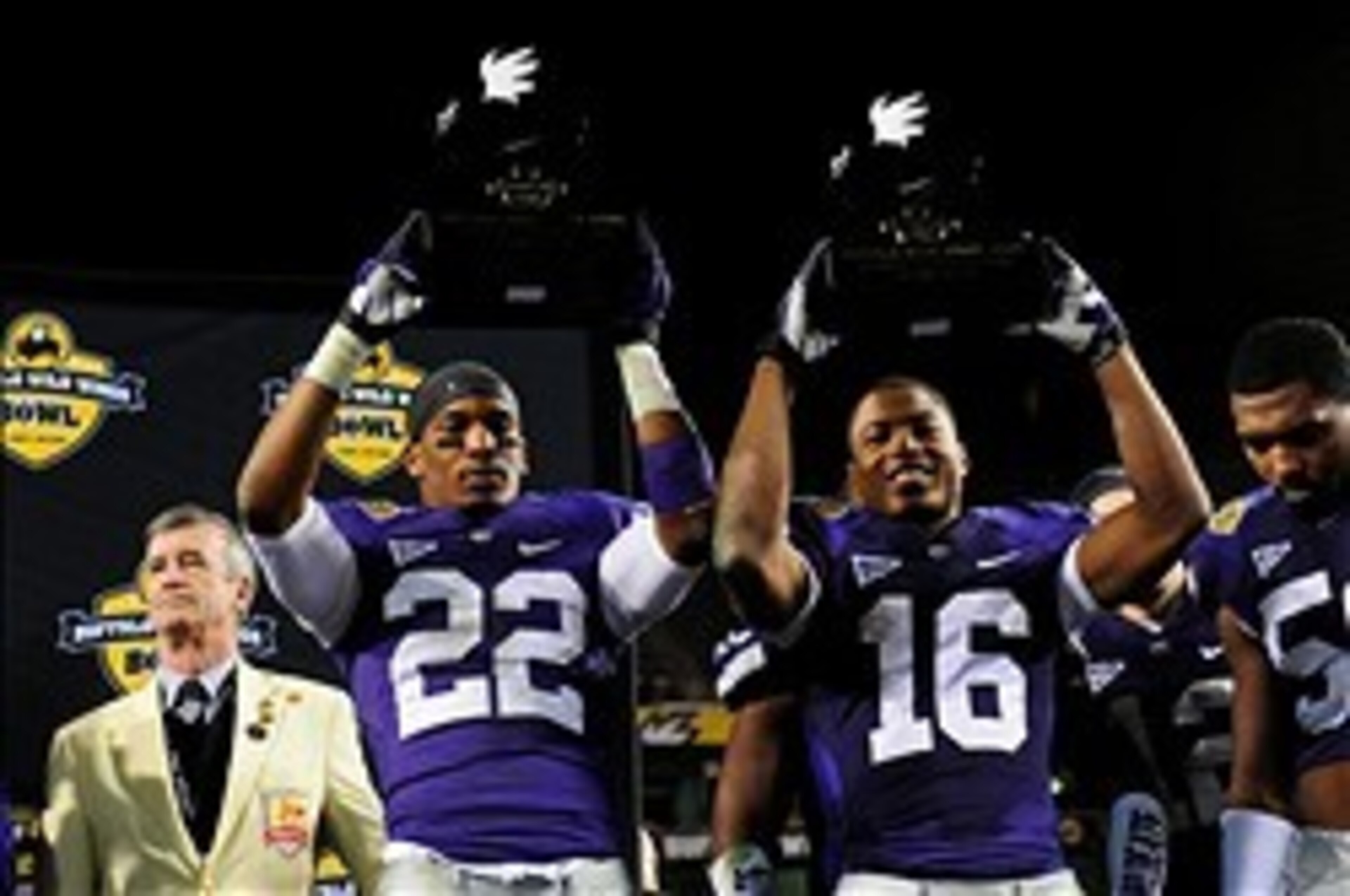 Dec 28, 2013; Tempe, AZ, USA; Kansas State Wildcats defensive back Carl Miles Jr. (2) and wide receiver Tyler Lockett (16) celebrate after winning defensive and offensive players of the game after beating the Michigan Wolverines 31-14 in the Buffalo Wild 