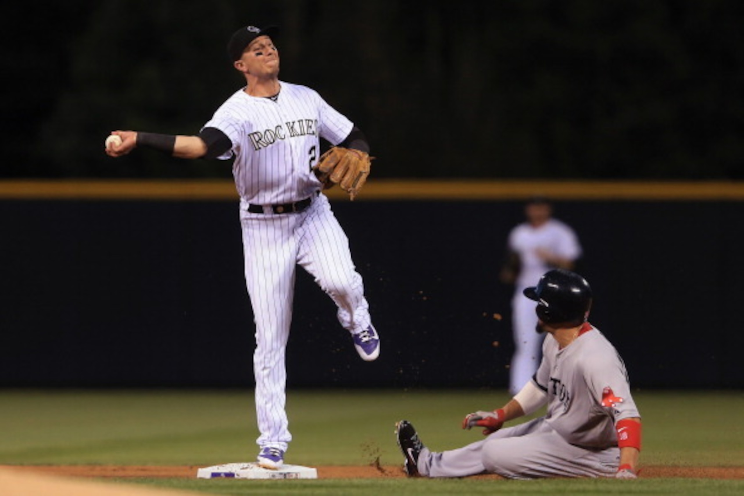 DENVER, CO - SEPTEMBER 25:  Shortstop Troy Tulowitzki #2 of the Colorado Rockies gets a force out on Shane Victorino #18 of the Boston Red Sox but was unable to complete the double play on Dustin Pedroia #15 of the Boston Red Sox in the first inning at Co