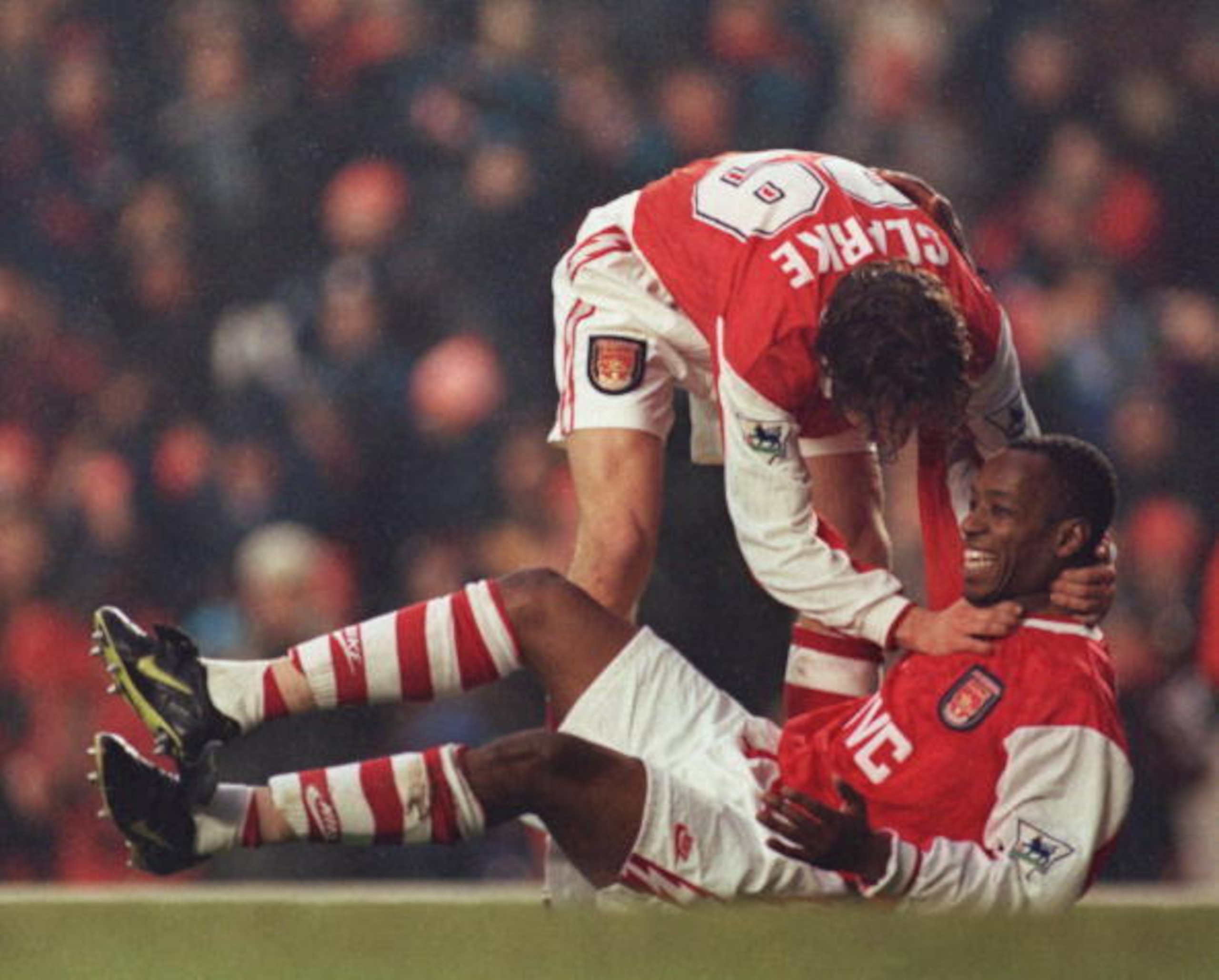 30 DEC 1995:  ADRIAN CLARKE HELPS IAN WRIGHT CELEBRATE HIS GOAL FOR ARSENAL AGAINST WIMBLEDON IN THE PREMIER LEAGUE MATCH AT HIGHBURY. WIMBLEDON WON 3-1. Mandatory Credit: Anton Want/ALLSPORT