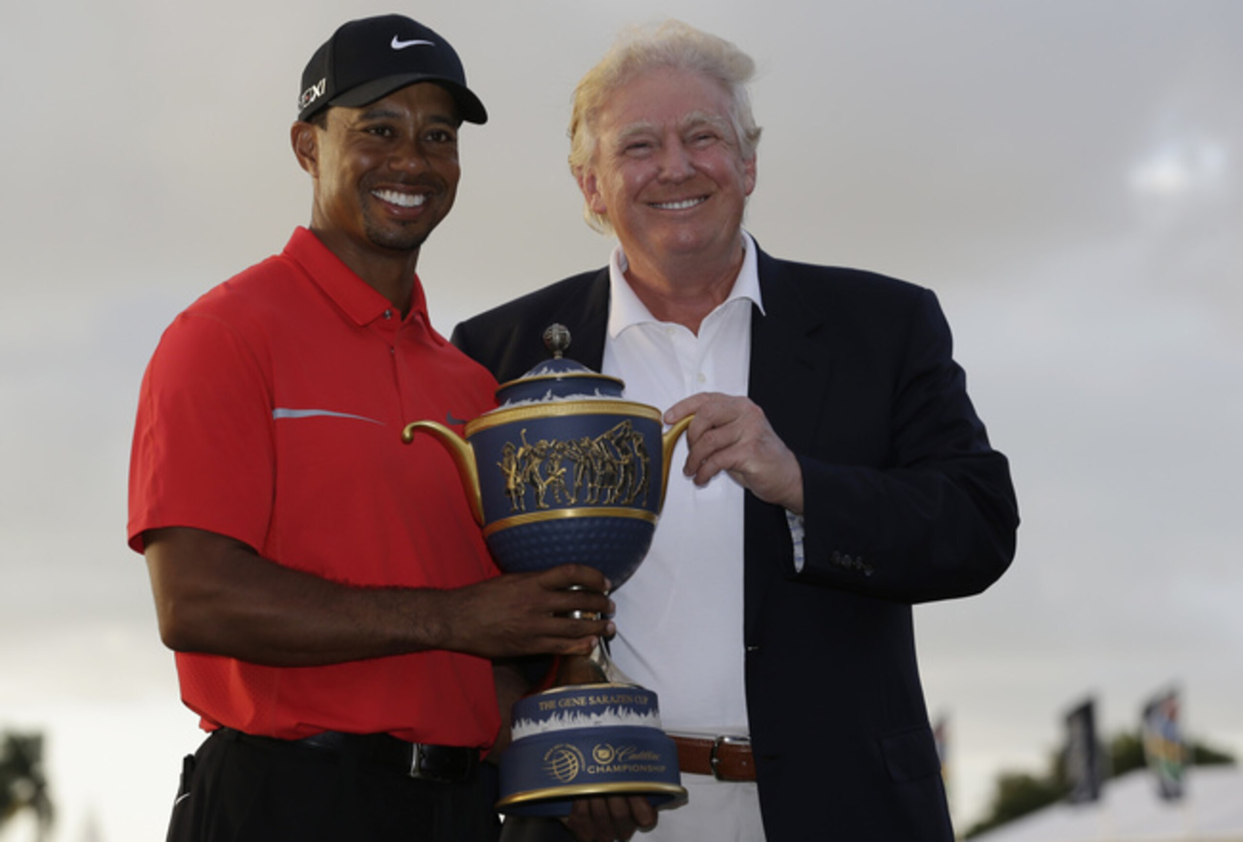 Donal Trump presented Tiger Woods the 2013 WGC-Cadillac trophy.