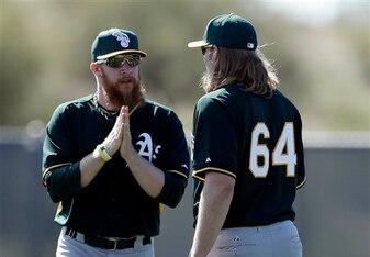 Arriving a week before position players, pitchers Sean Doolittle (left) and A.J. Griffin have a chat.