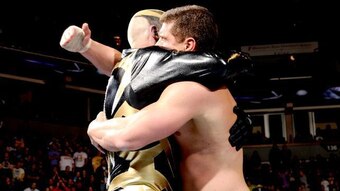 The Rhodes brothers embrace in a hug after defeating Curtis Axel and Ryback.