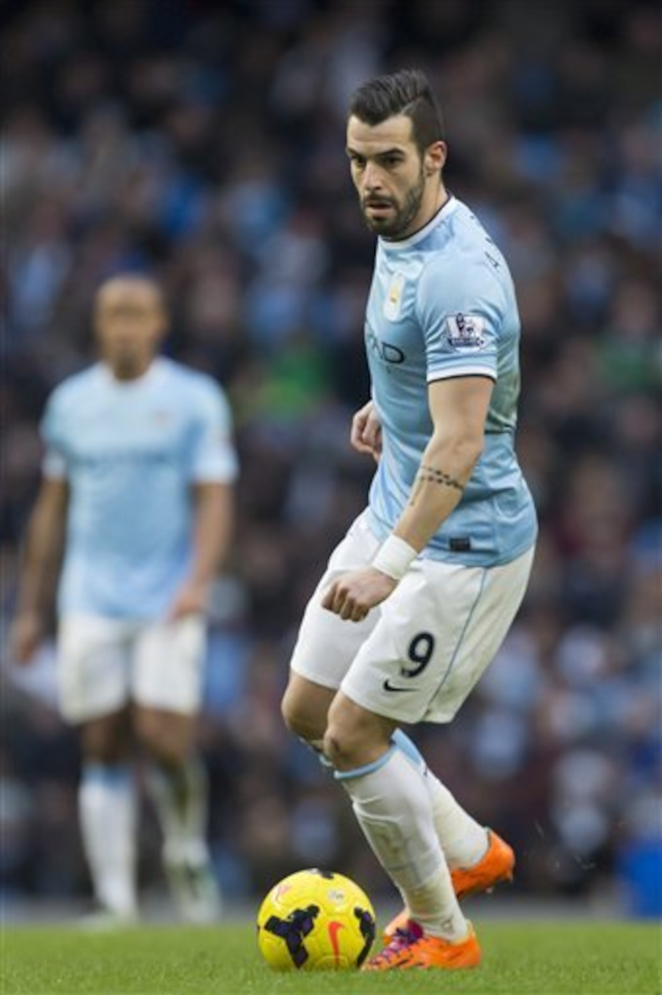 Manchester City's Alvaro Negredo takes the ball downfield during his team's English Premier League soccer match against Stoke at the Etihad Stadium, Manchester, England, Saturday, Feb. 22, 2014. (AP Photo/Jon Super)