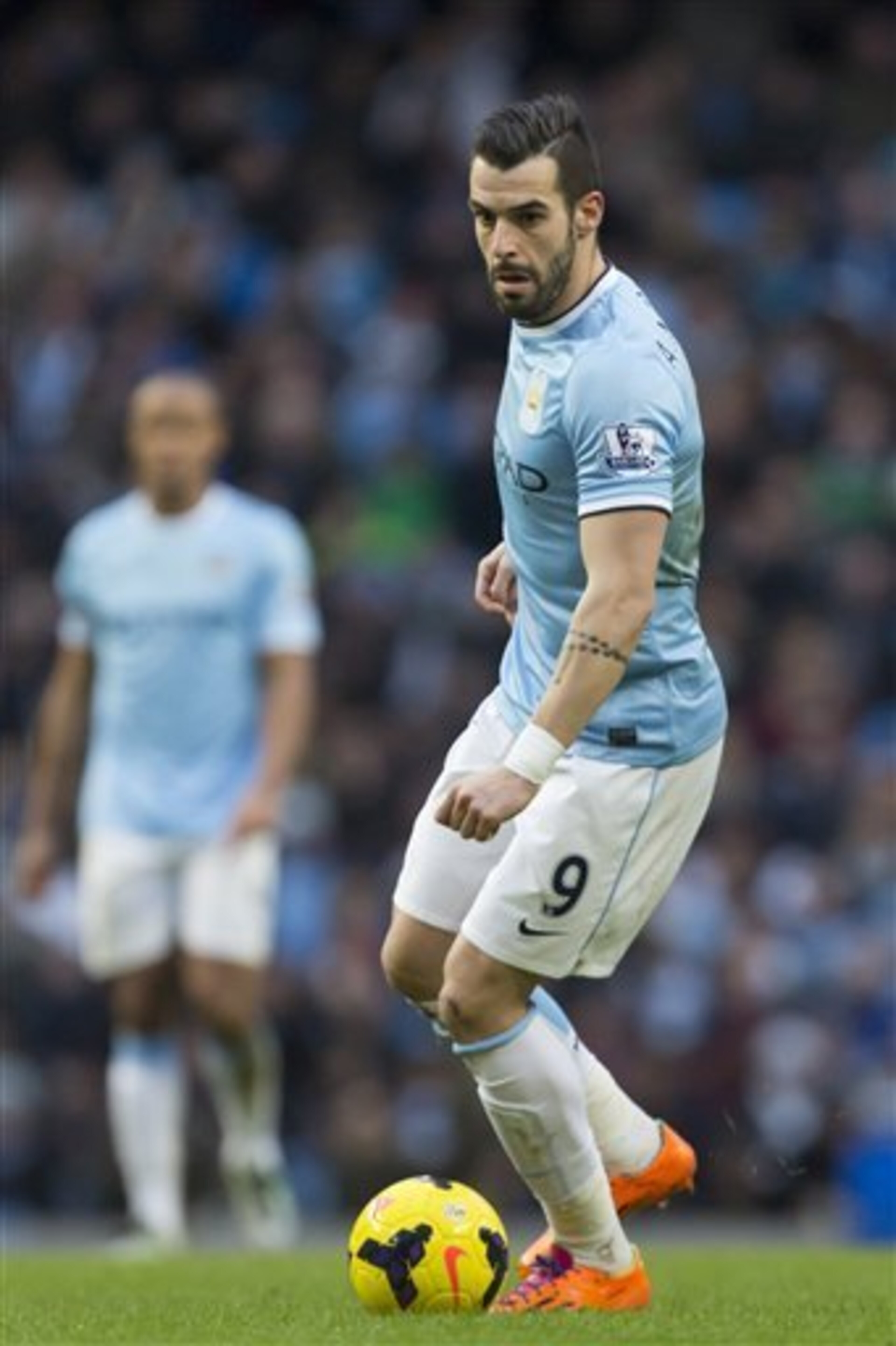 Manchester City's Alvaro Negredo takes the ball downfield during his team's English Premier League soccer match against Stoke at the Etihad Stadium, Manchester, England, Saturday, Feb. 22, 2014. (AP Photo/Jon Super)