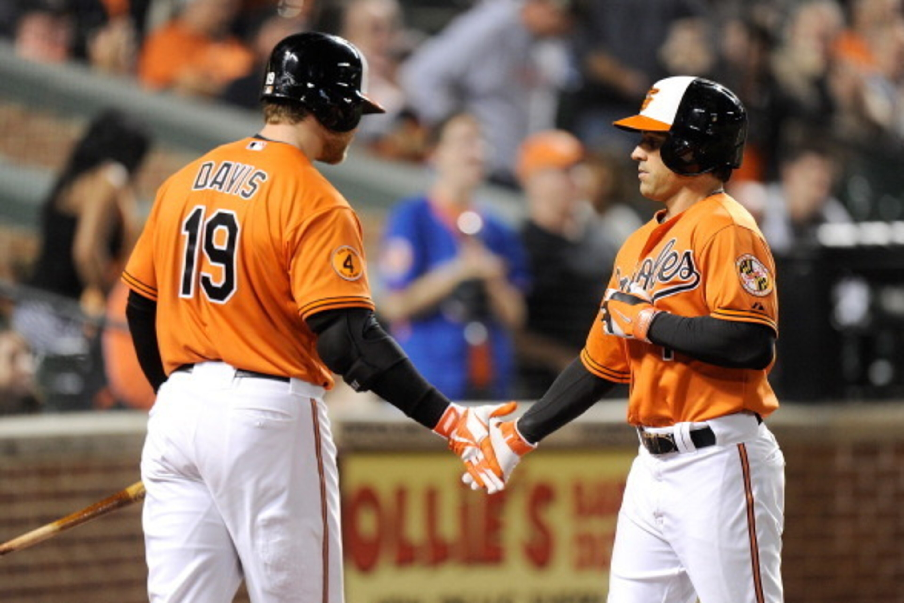 BALTIMORE, MD - SEPTEMBER 28:  Brian Roberts #1 of the Baltimore Orioles celebrates with Chris Davis #19 after hitting a home run in the third inning against the Boston Red Sox at Oriole Park at Camden Yards on September 28, 2013 in Baltimore, Maryland.  