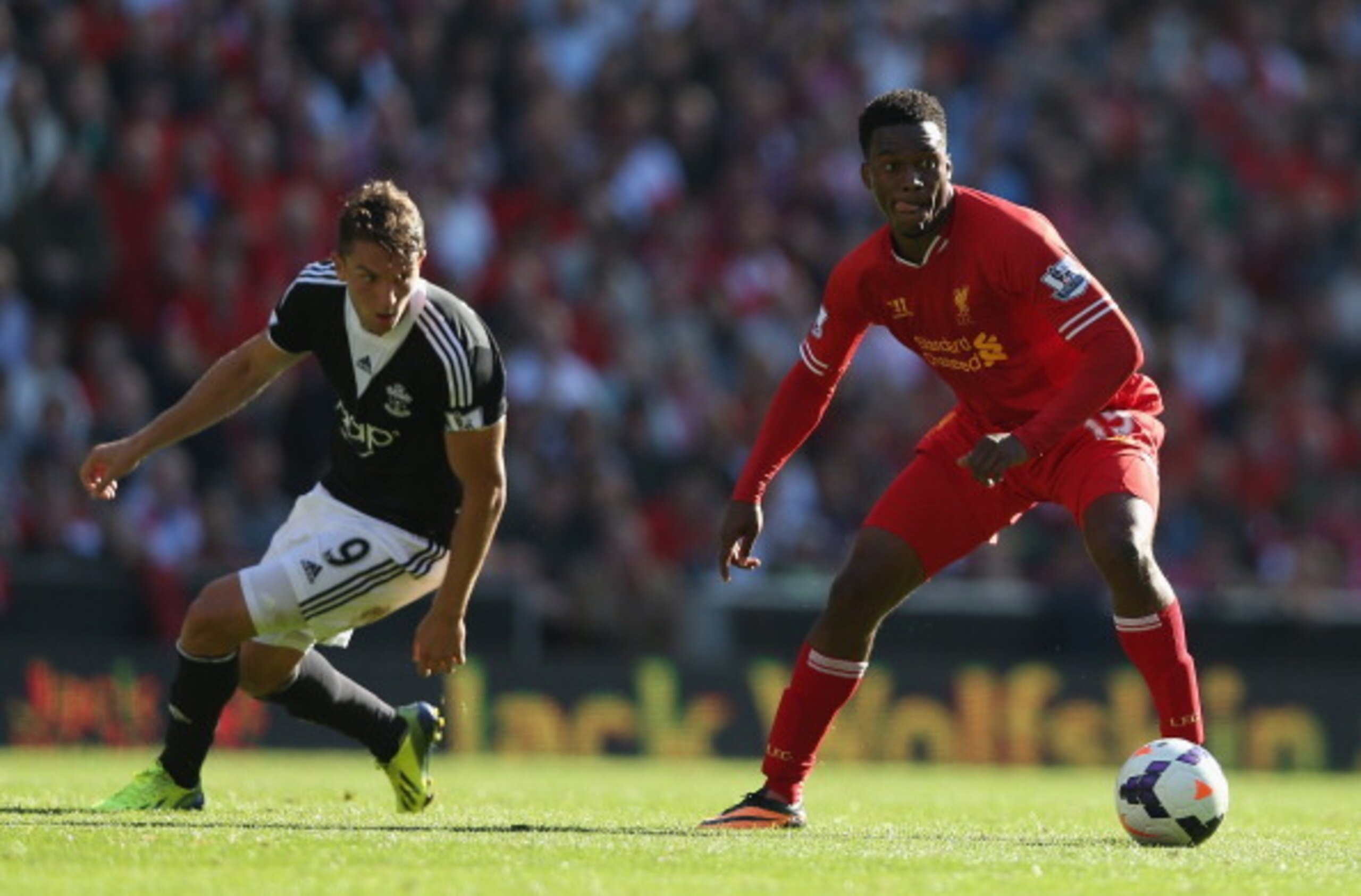 LIVERPOOL, ENGLAND - SEPTEMBER 21:  Daniel Sturridge of Liverpool moves away from Jay Rodriguez of Southampton during the Barclays Premier League match between Liverpool and Southampton at Anfield on September 21, 2013 in Liverpool, England.  (Photo by Cl