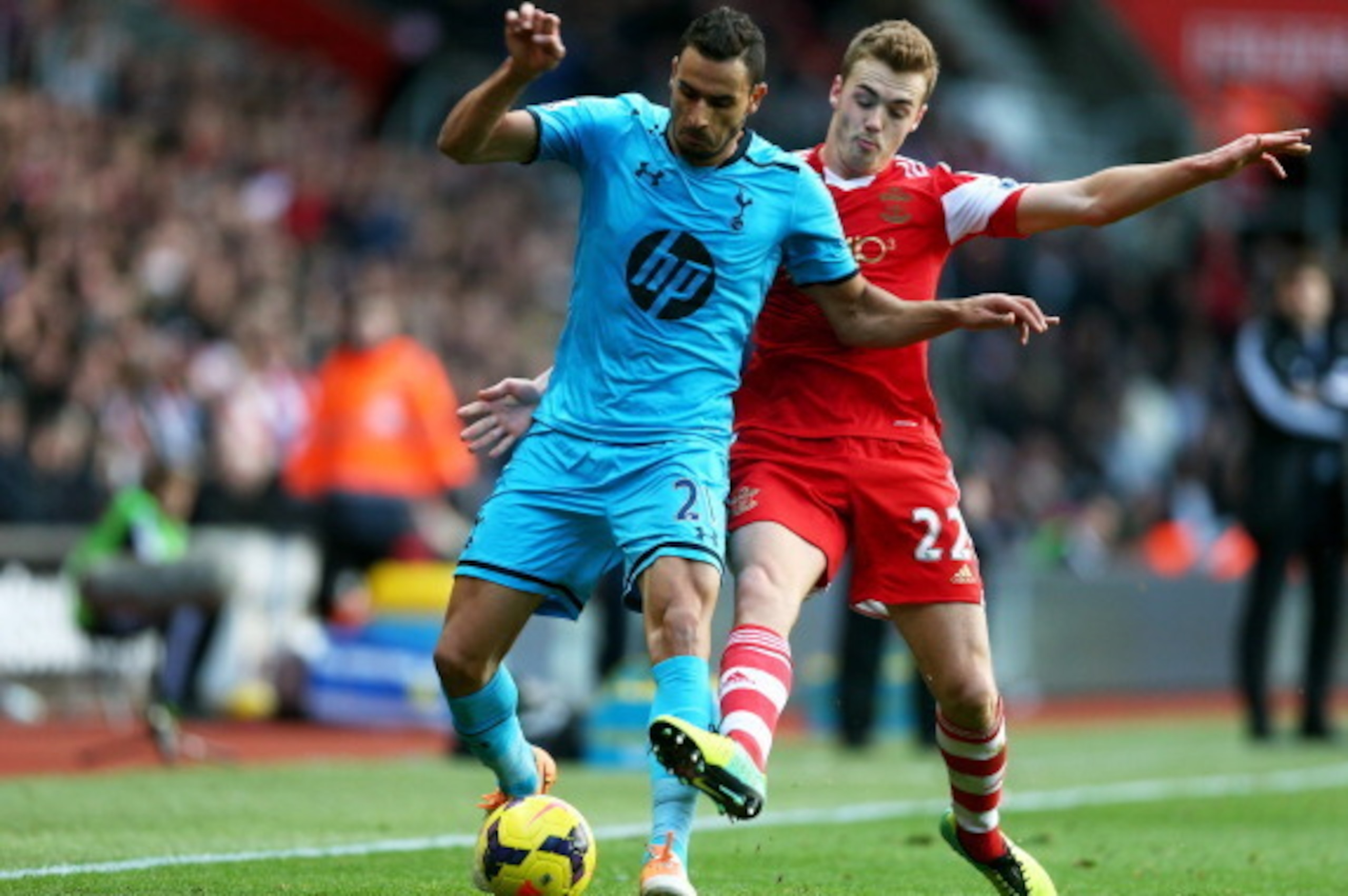SOUTHAMPTON, ENGLAND - DECEMBER 22:  Nacer Chadli of Spurs holds off the challenge from Calum Chambers of Southampton during the Barclays Premier League match between Southampton and Tottenham Hotspur at St Mary's Stadium on December 22, 2013 in Southampt