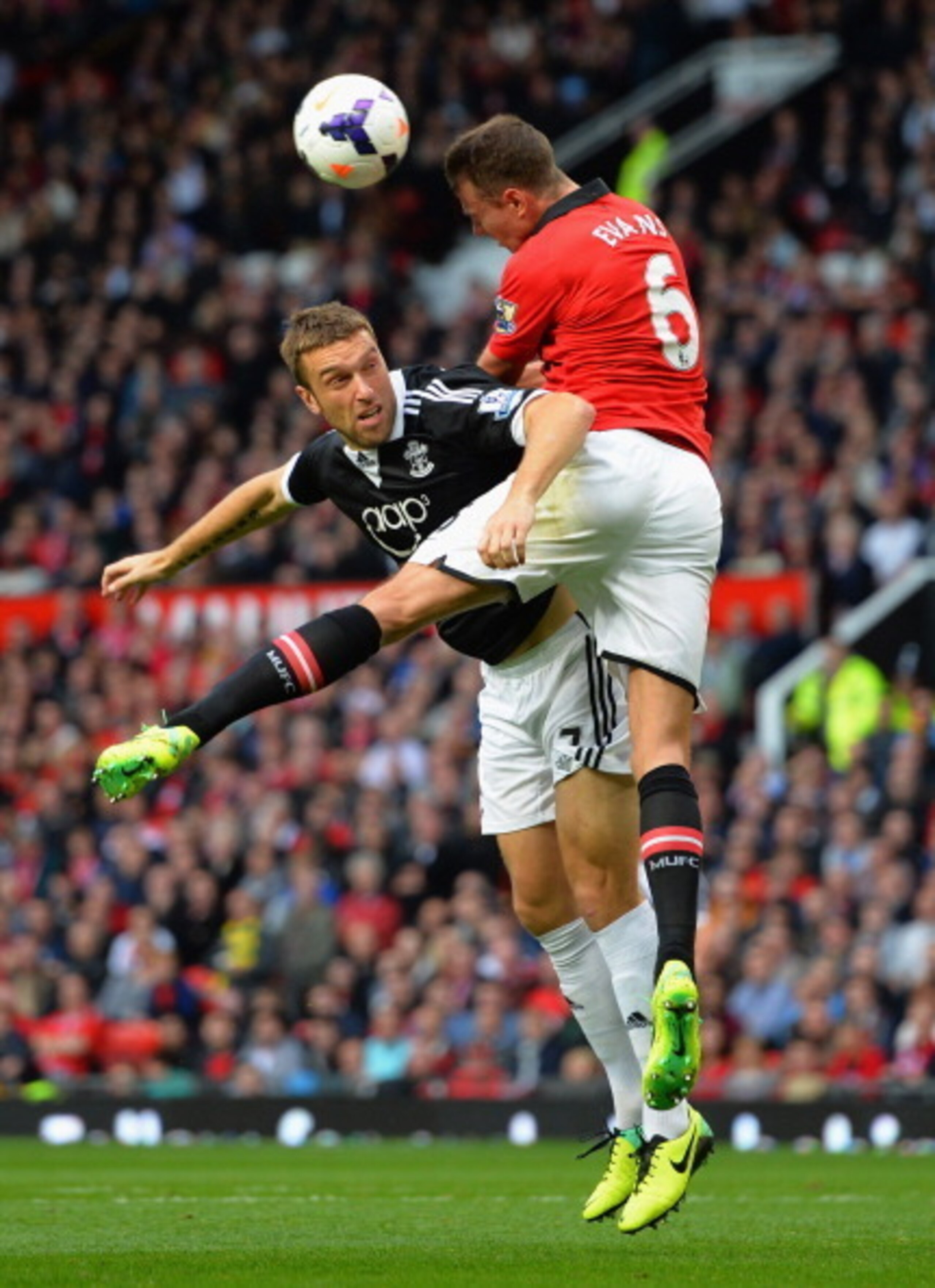 MANCHESTER, ENGLAND - OCTOBER 19:  Jonny Evans of Manchester United and Rickie Lambert of Southampton challenge for the ball during the Barclays Premier League match between Manchester United and Southampton at Old Trafford on October 19, 2013 in Manchest
