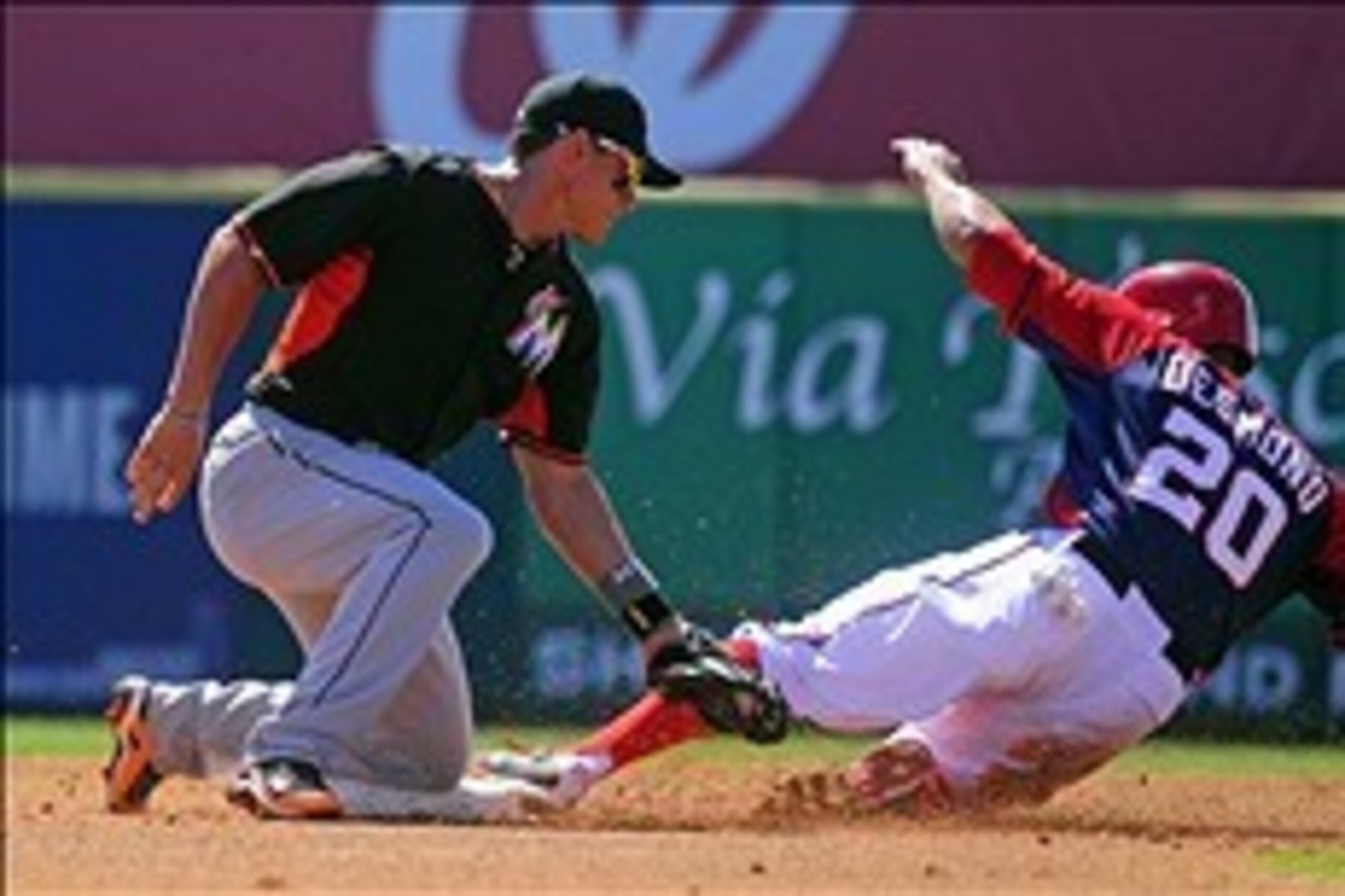 Mar 2, 2014; Melbourne, FL, USA; Washington Nationals shortstop Ian Desmond (20) steals second base in front go Miami Marlins second baseman Derek Dietrich (32) in the first inning as the Nationals beat the Marlins 10-3 in a spring training exhibition gam