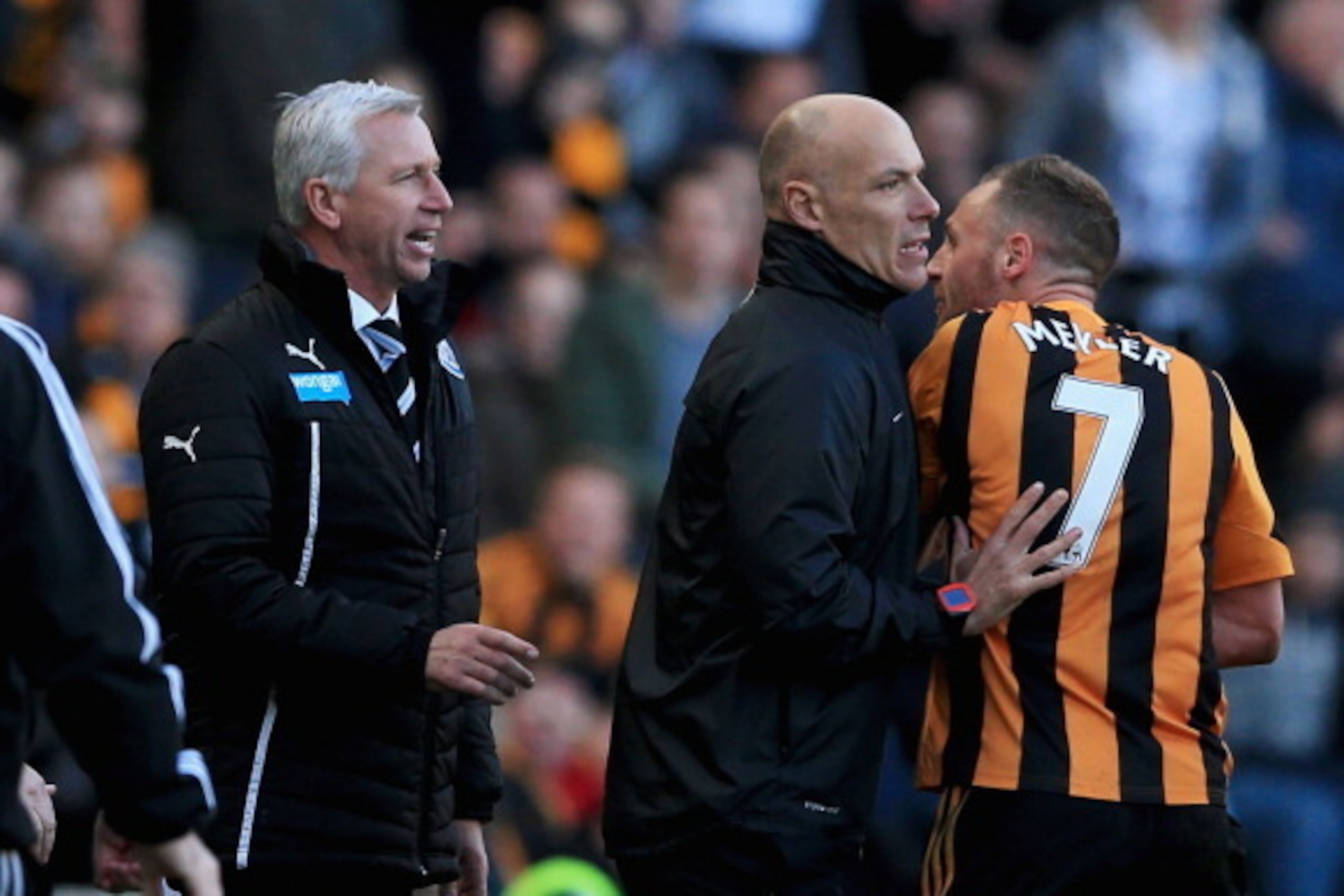 HULL, ENGLAND - MARCH 01:  Fourth official Howard Webb restrains David Meyler of Hull City (7) after a clash with Alan Pardew manager of Newcastle United (L) during the Barclays Premier League match between Hull City and Newcastle United at KC Stadium on 