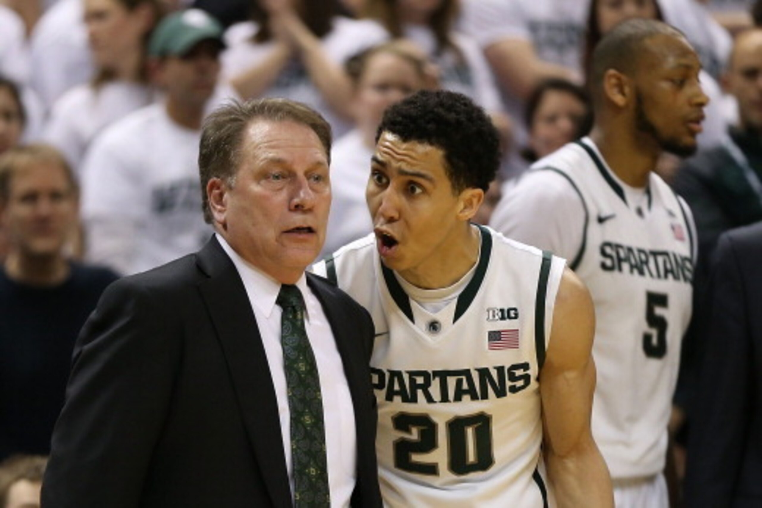 EAST LANSING, MI - MARCH 01: Travis Trice #20 of the Michigan State Spartans talks with head basketball coach Tom Izzo late in the second half of the game against the University of Illinois at the Breslin Center on March 1, 2014 in East Lansing, Michigan.
