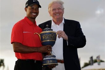 Tiger Woods won the 2013 WGC-Cadillac and received the trophy from Donald Trump. Tiger Woods won the 2013 WGC-Cadillac and received the trophy from Donald Trump.