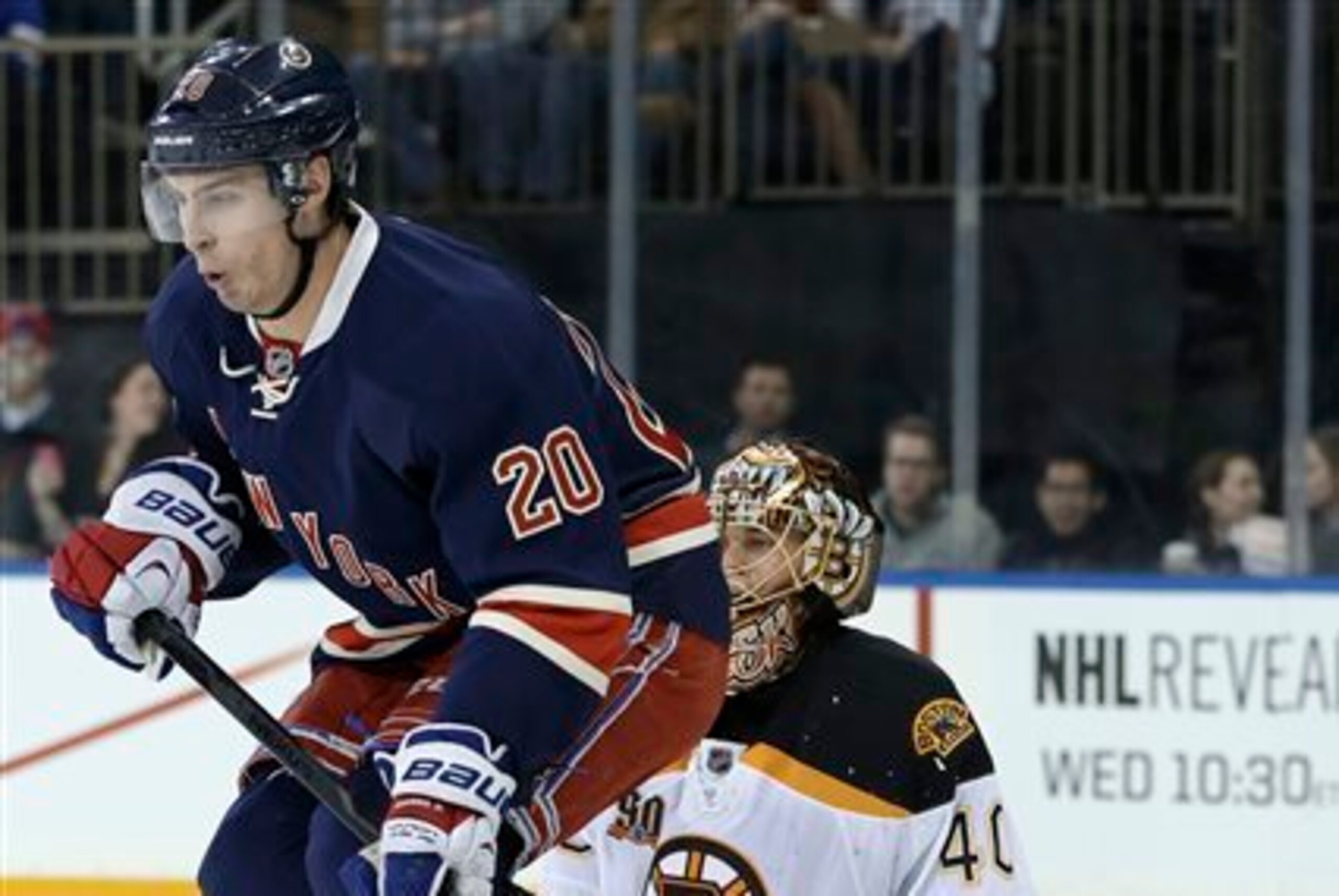New York Rangers' Chris Kreider, left, jumps up in front of Boston Bruins goalie Tuukka Rask during the second period of an NHL hockey game Sunday, March 2, 2014, in New York. (AP Photo/Seth Wenig)