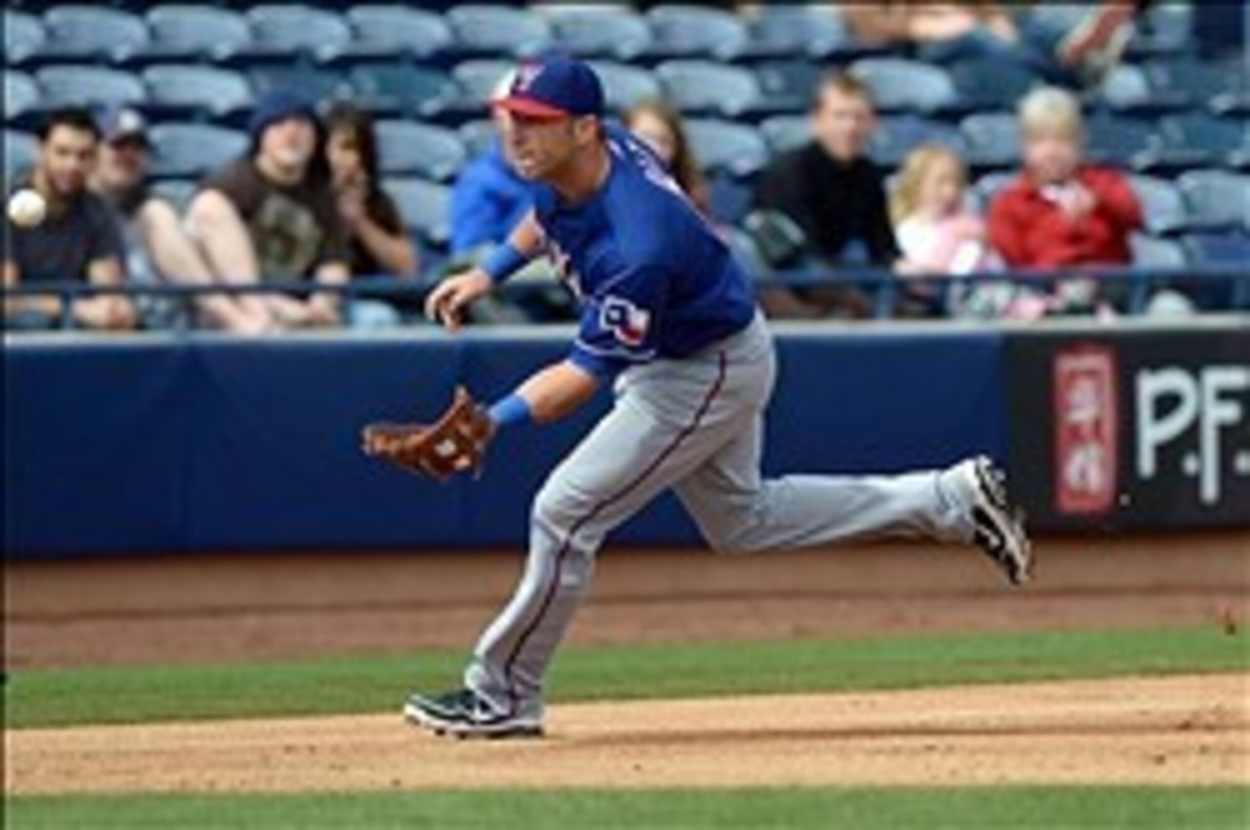 Mar 9, 2013; Peoria, AZ, USA; Texas Rangers third baseman Mike Olt (9) chases a grounder by San Diego Padres second baseman Jedd Gyorko (not pictured) before throwing him out at first during the second inning at Peoria Sports Complex. Mandatory Credit: Ja