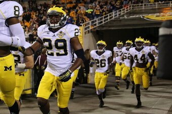 TEMPE, AZ - DECEMBER 28:  Defensive back Ross Douglas #29 of the Michigan Wolverines runs out with teammates before the Buffalo Wild Wings Bowl against the Kansas State Wildcats at Sun Devil Stadium on December 28, 2013 in Tempe, Arizona.  The Wildcats de