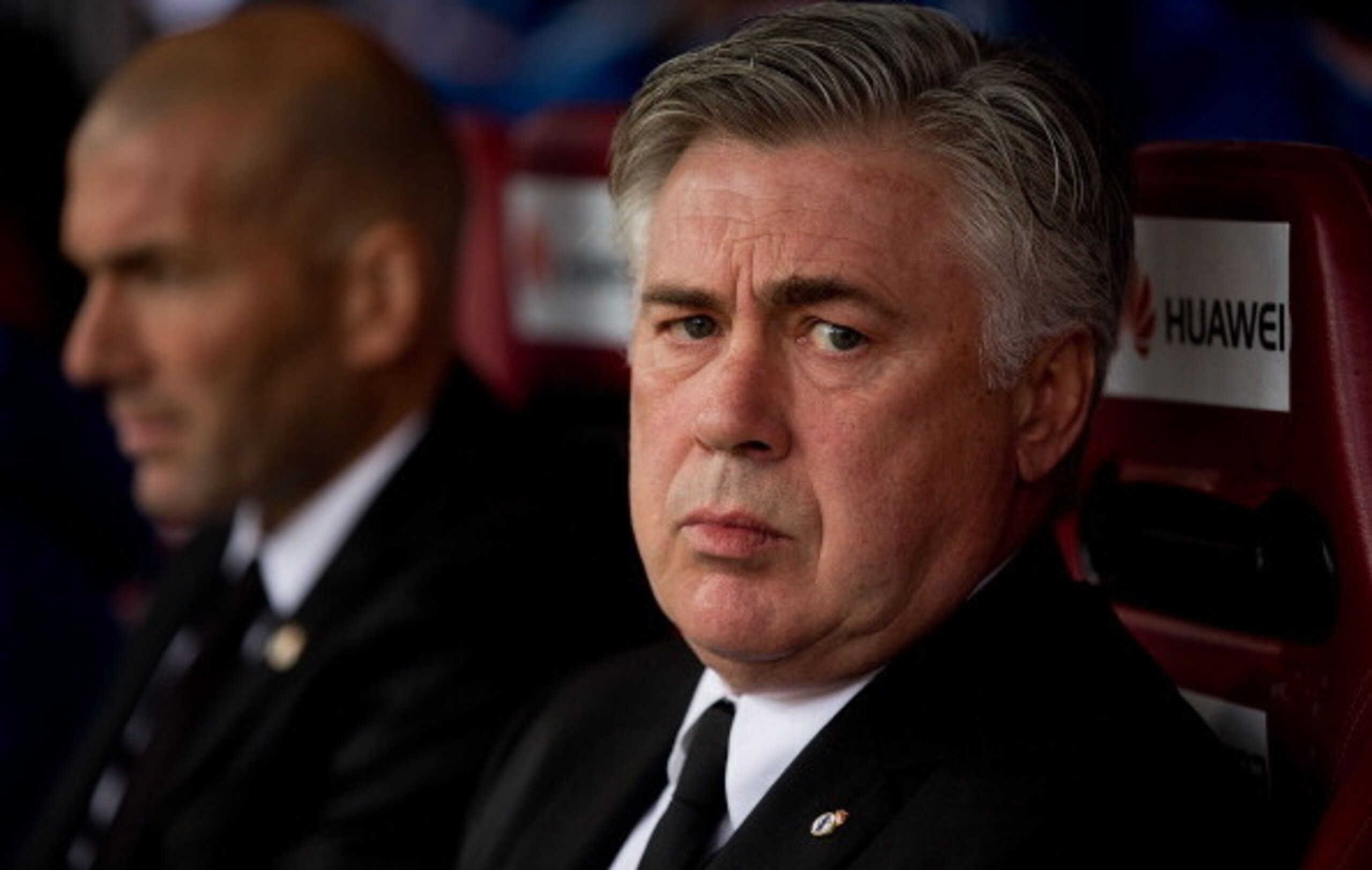 MADRID, SPAIN - MARCH 02: Head coach Carlo Ancelotti (R) of Real Madrid CF looks on sitted on the bench close to assistant coach Zinedine Zidane (L) prior to start the La Liga match between Club Atletico de Madrid and Real Madrid CF at Vicente Calderon St