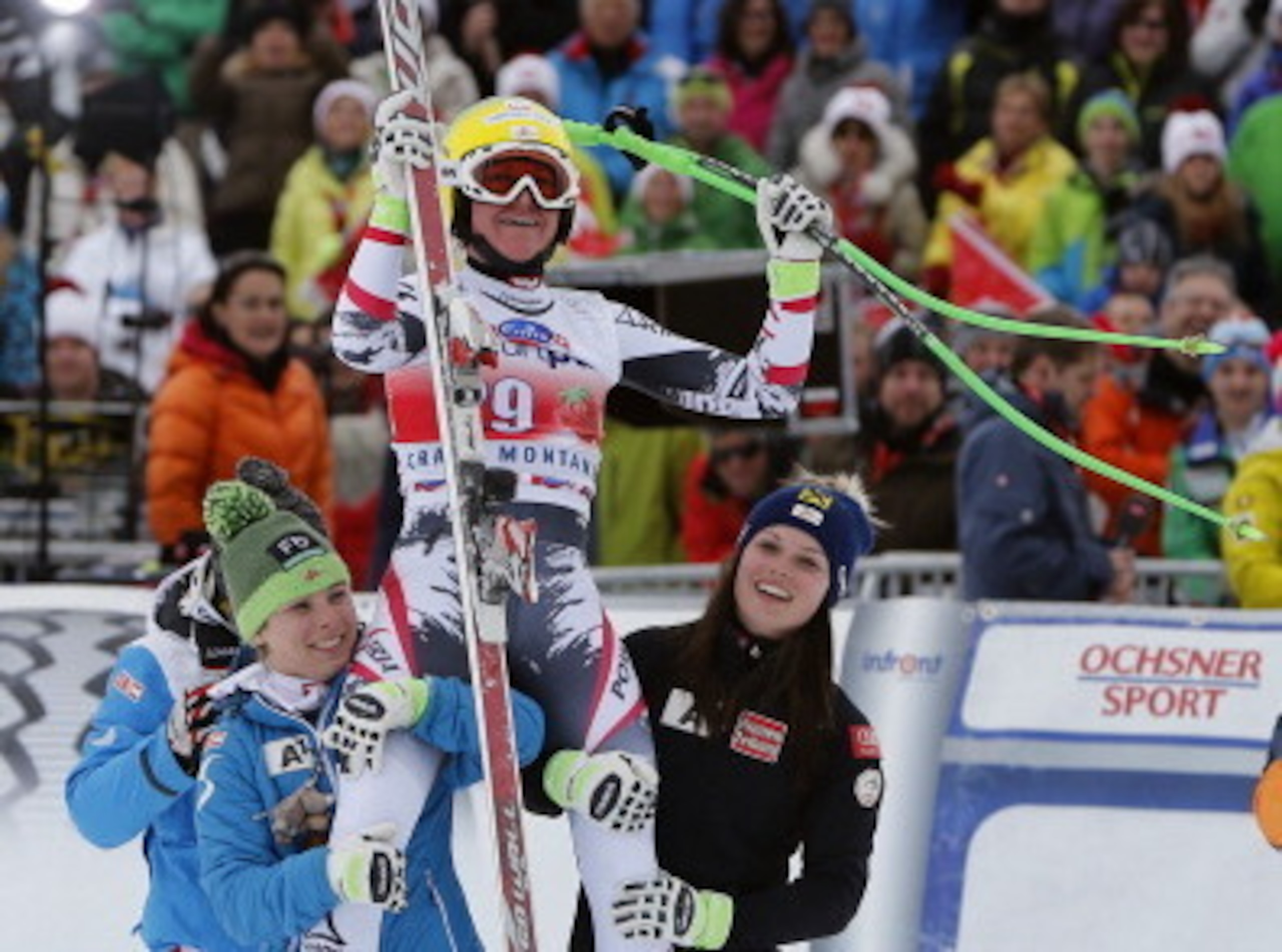On top of the world! Andrea Fischbacher is held aloft by her Austria teammates after a surprise win in Crans Montana.