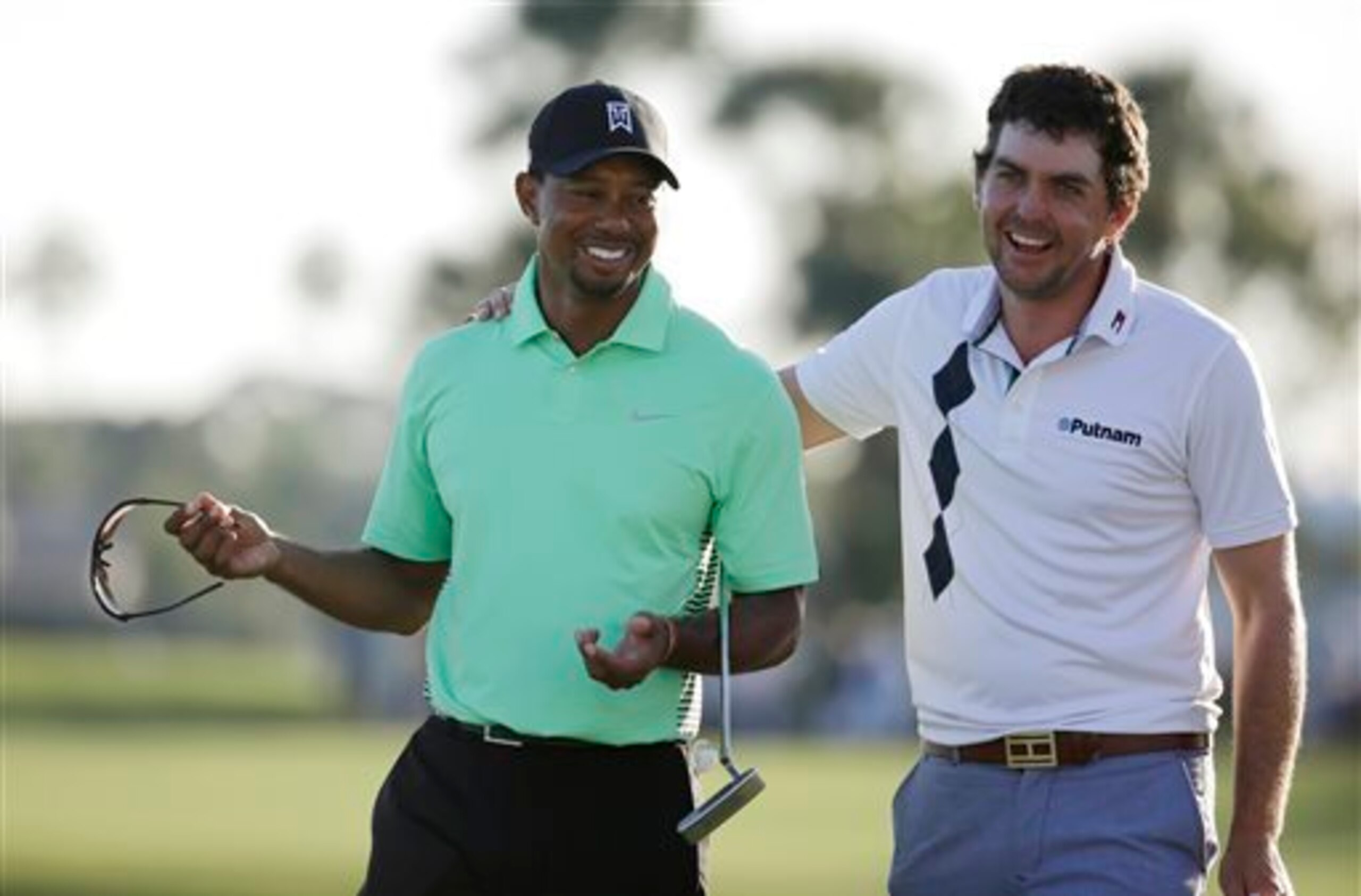 Keegan Bradley shares a laugh with Tiger Woods.