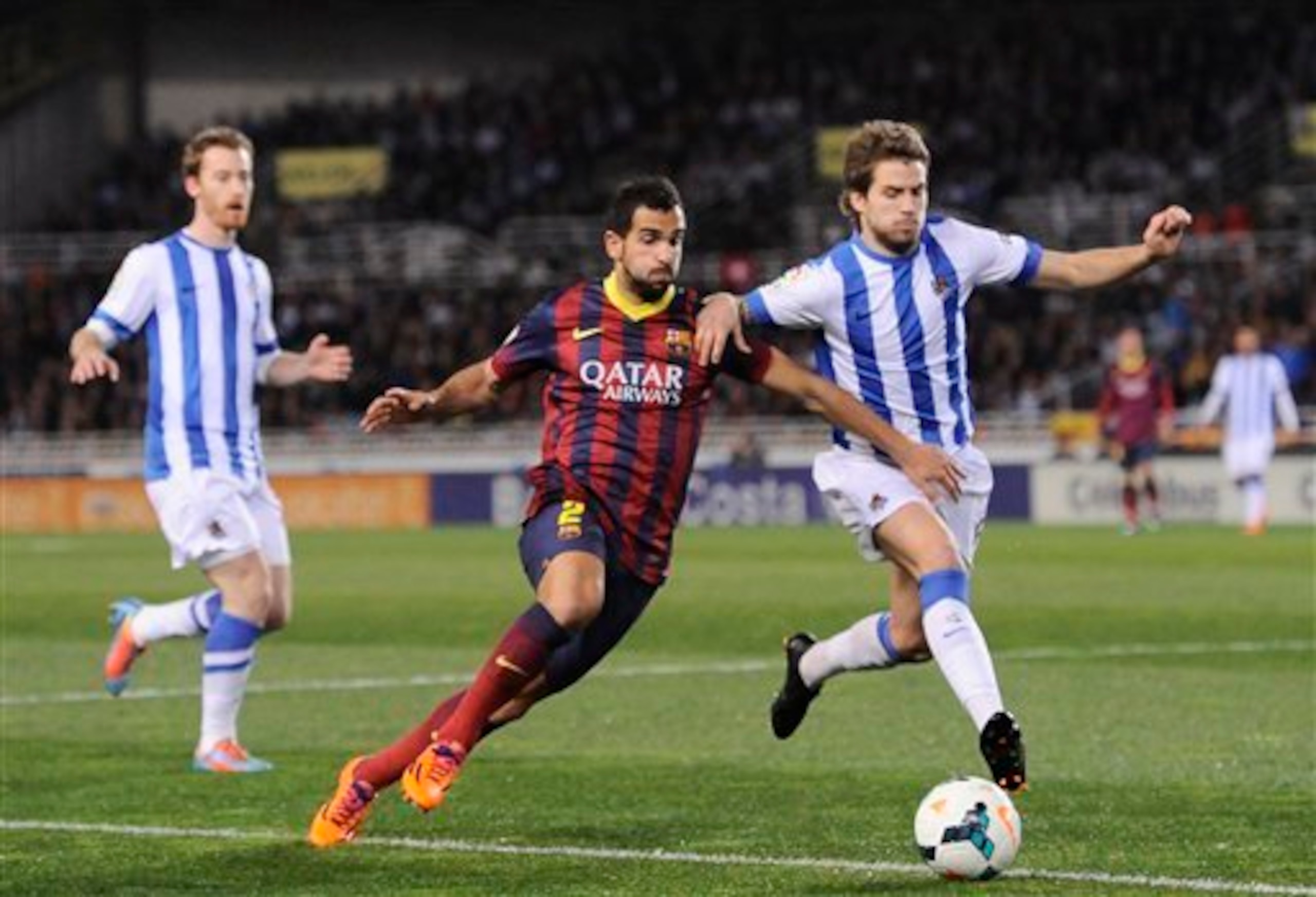 Barcelona's Martin Montoya jostles for possession.
